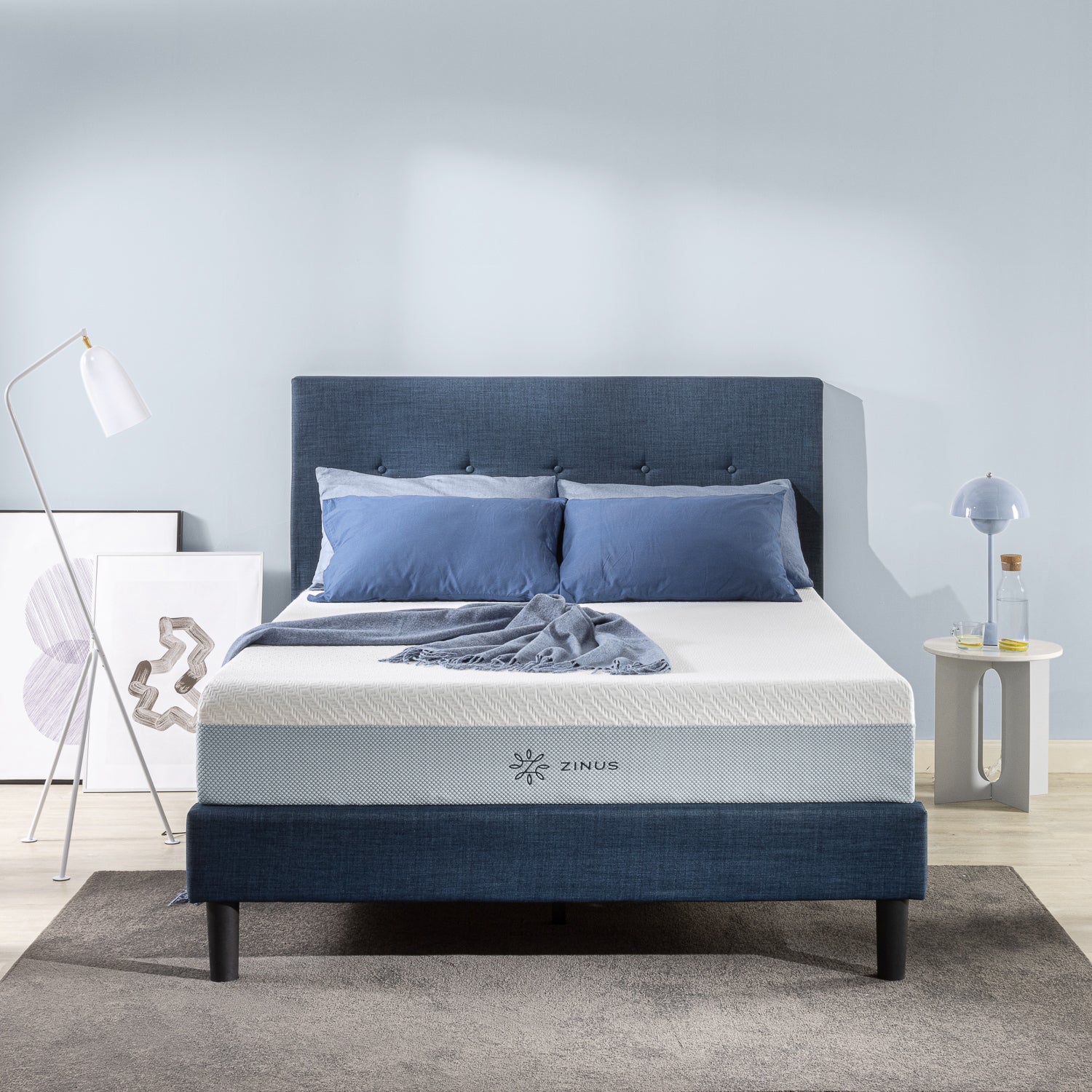 Memory foam mattress paired with blue bedding and headboard