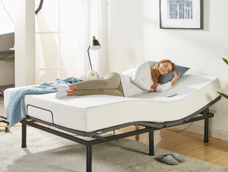 Person resting on an adjustable bed with the head and foot sections elevated, showing a supportive mattress, remote control on the side, and a bright bedroom setup with soft lighting and minimal decor to highlight customized comfort.