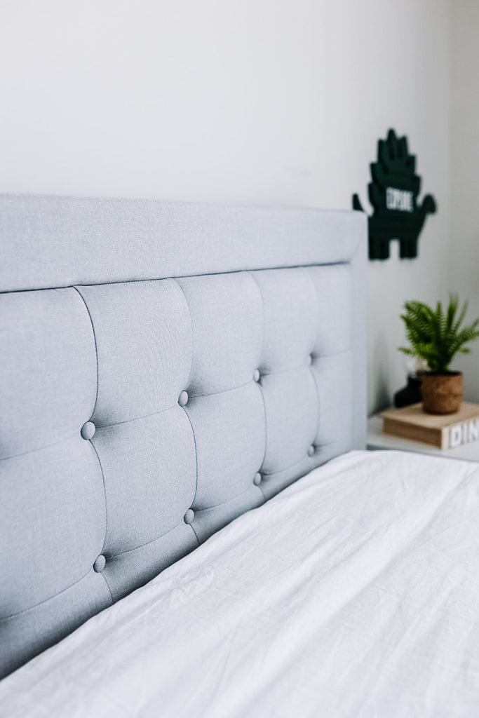 Light gray upholstered headboard paired with a neatly made Zinus mattress, highlighting tufted fabric details, clean stitching, and a modern, minimalist bedroom style that emphasizes comfort, support, and soft, neutral design.