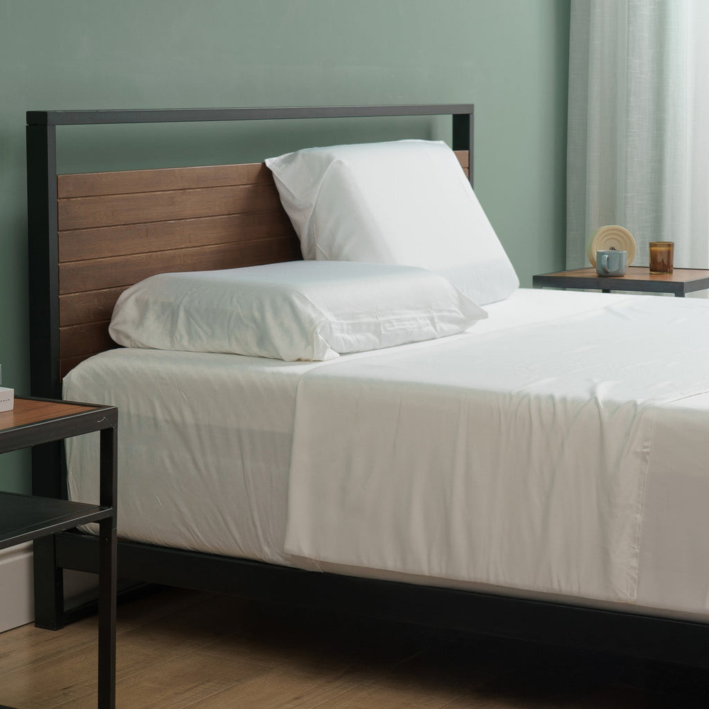 Zinus Modern platform bed with wood headboard, white bedding, and simple bedside table accents.