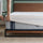 Person adjusting a white mattress protector over the Ultra Cooling Green Tea Hybrid Mattress placed on the Zinus Suzanne Platform Bed, showcasing the textured blue cover and breathable design for all-night cooling and pressure relief.