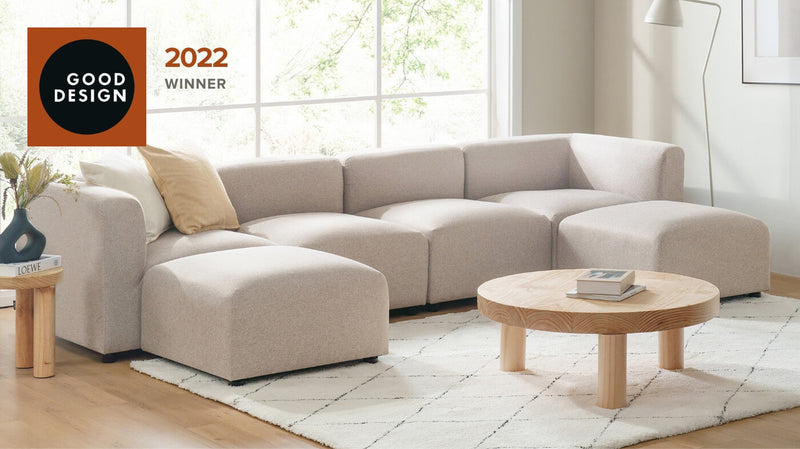 Zinus Luca Double Chaise sectional sofa in beige fabric shown in a bright living room with natural light.  The sectional is complimented with white throw pillows set on a neutral area rug on hardwood floors.