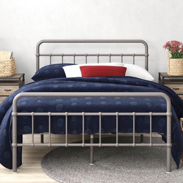 Zinus Florence Metal Platform Bed Frame with headboard, styled with blue bedding and a wicker storage basket beneath. Sturdy steel frame adds modern farmhouse charm while supporting queen or full mattresses with underbed storage space