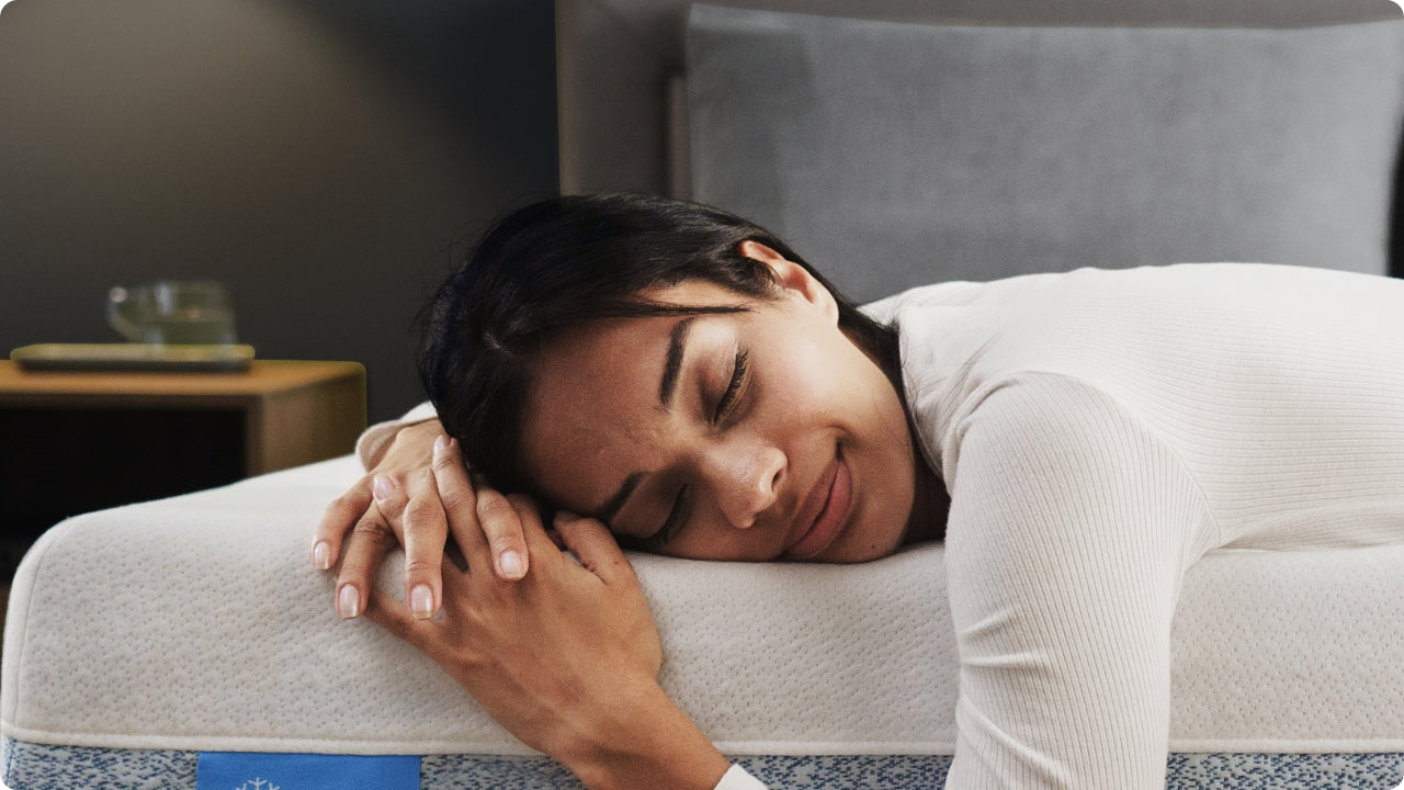 Person resting on soft hybrid mattress with breathable foam surface, showing comfort and support in a calm bedroom.