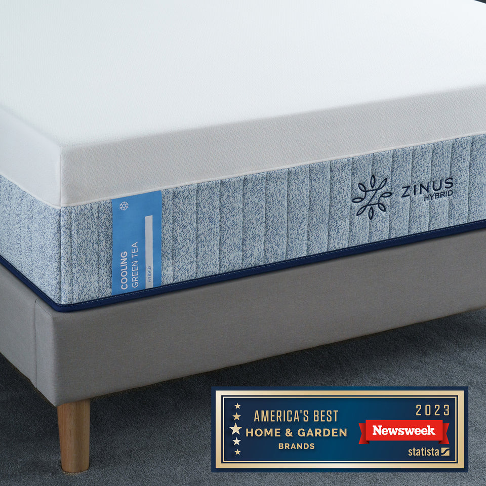 Close-up of Zinus Cooling Green Tea Hybrid Mattress on bed frame. Features cooling gel memory foam, supportive innerspring system, and green tea infusion for freshness. Recognized by Newsweek 2023 as one of America’s Best Home & Garden Brands