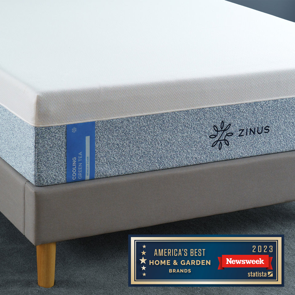 Close-up of Zinus Cooling Green Tea Memory Foam Mattress on platform bed. Blue speckled cover with cooling technology and natural green tea infusion offers fresh, breathable comfort and pressure relief. Recognized as America’s Best Home & Garden Brand 2023 by Newsweek.