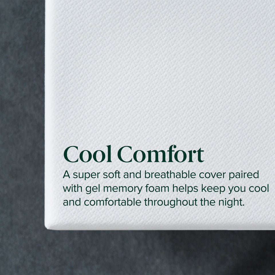 Zinus Cooling Green Tea Memory Foam Mattress corner detail showing the textured white knit cover against a dark grey background. Overlaid text reads: Cool Comfort. A super soft and breathable cover paired with gel memory foam helps keep you cool and comfortable throughout the night.