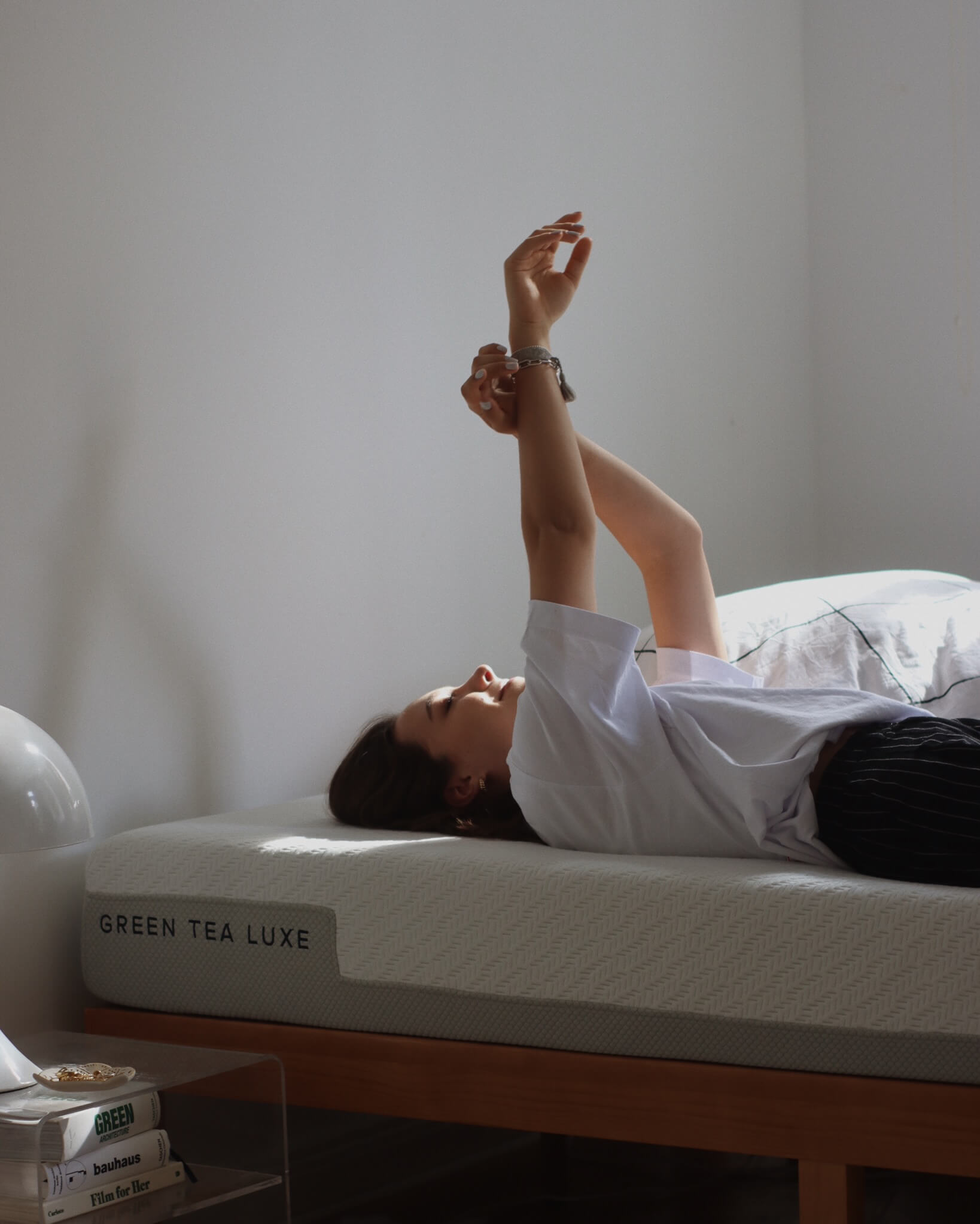 girl laying on green tea luxe mattress
