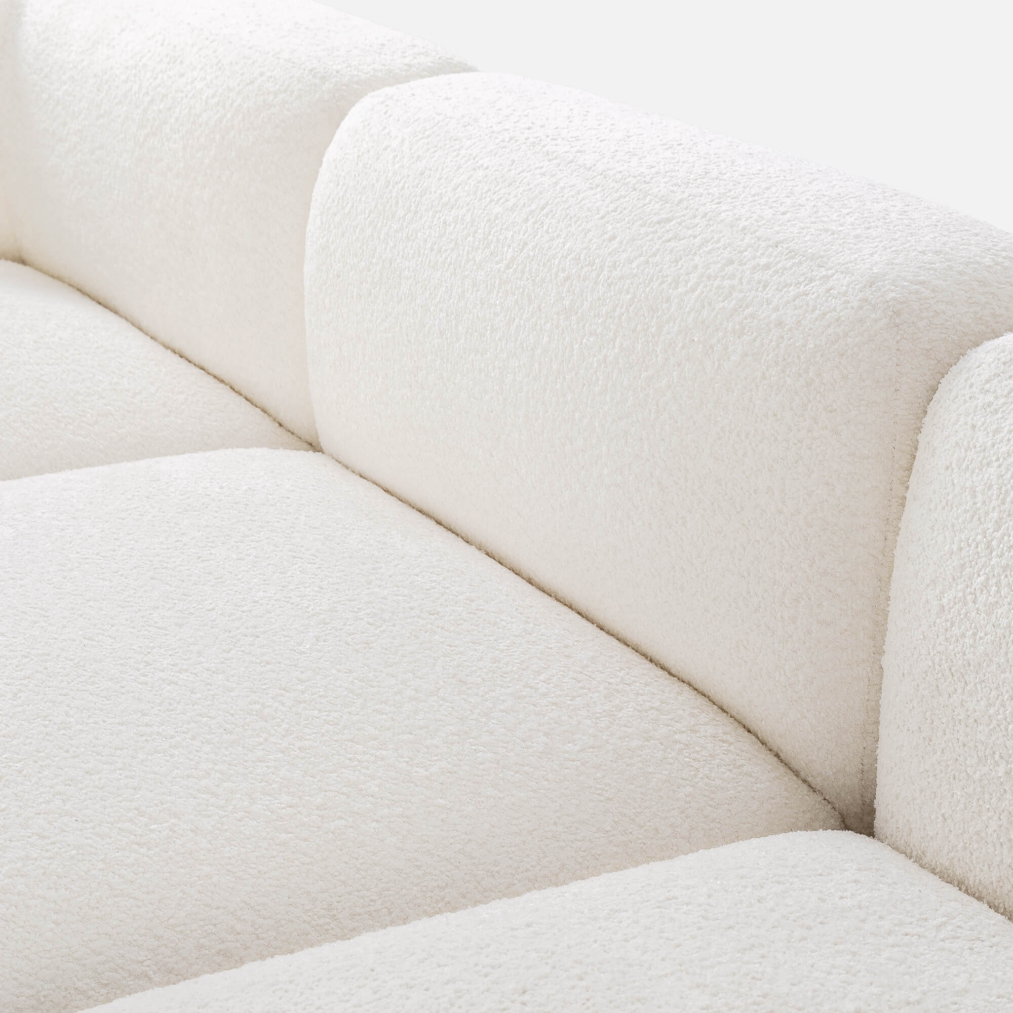 Detailed view of the Luca Double Chaise Sectional's boucle upholstery and cushions