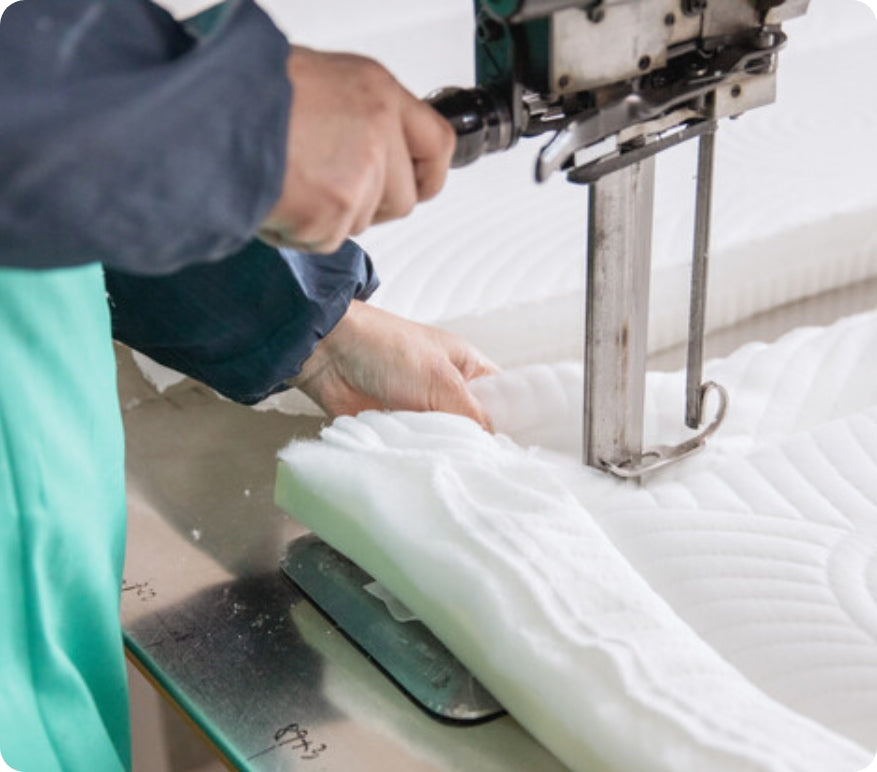 Natural and recycled mattress materials including green tea–infused memory foam, breathable fiber padding, bamboo panel, perforated latex foam, molded pulp packaging insert, and plant leaf, conveying eco-conscious design and sustainable comfort components.