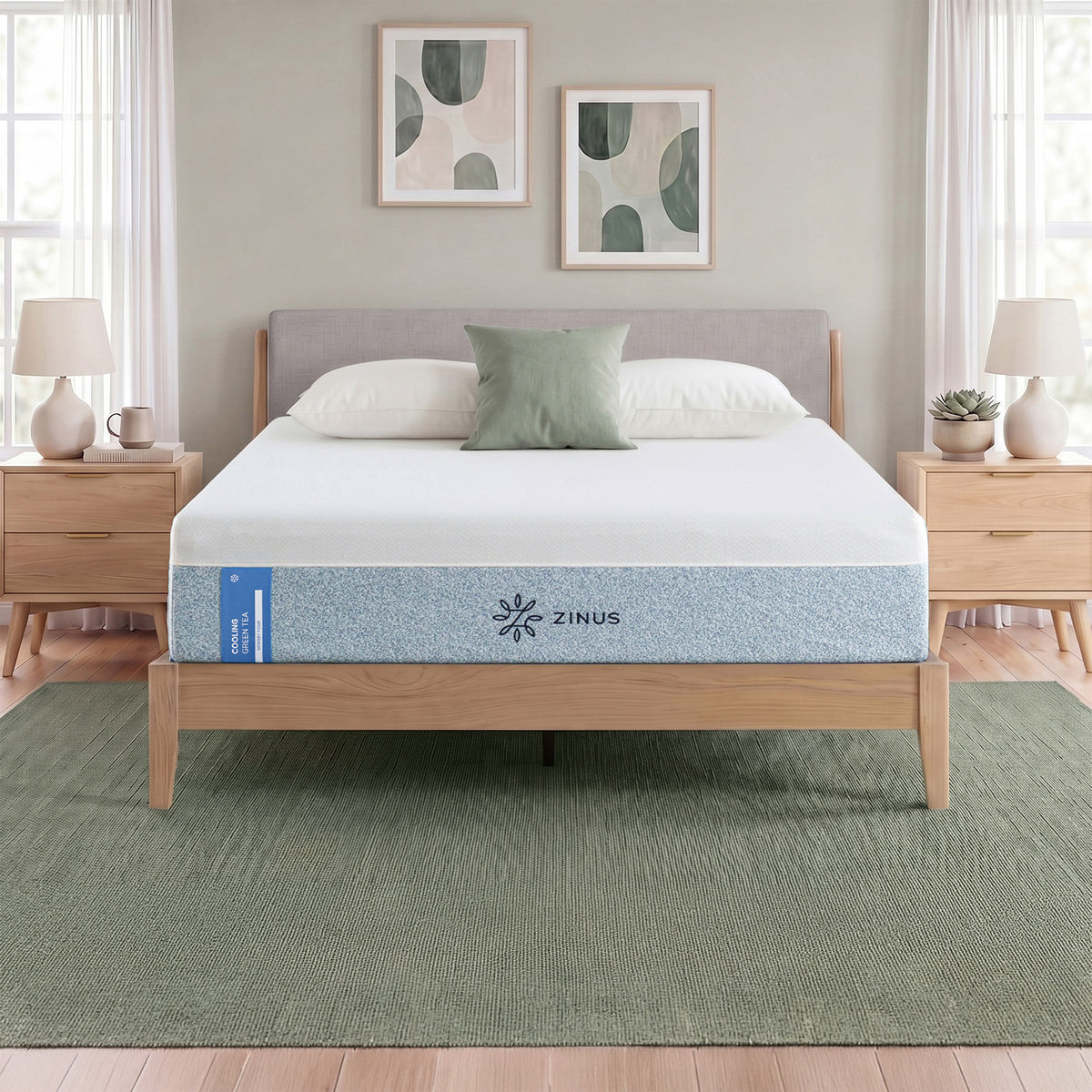 Zinus Cooling Green Tea Memory Foam Mattress, Queen, staged on wood platform bed frame in bedroom with white pillows, sage cushion, and label text reading cooling green tea memory foam.