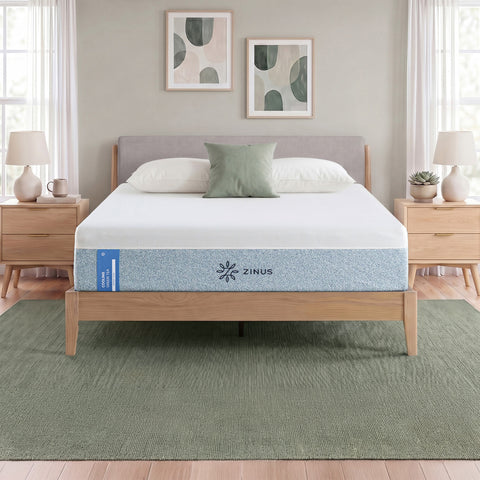 Zinus Cooling Green Tea Memory Foam Mattress, Queen, staged on wood platform bed frame in bedroom with white pillows, sage cushion, and label text reading cooling green tea memory foam.
