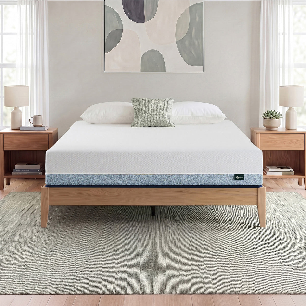 Zinus Original Green Tea Hybrid Mattress, Queen, on light wood platform bed frame in bright bedroom with white and sage pillows, matching nightstands, lamps, books, and a succulent plant.
