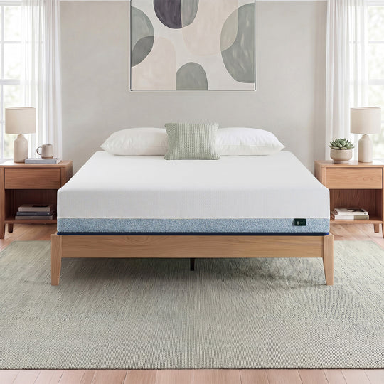 Zinus Original Green Tea Hybrid Mattress, Queen, on light wood platform bed frame in bright bedroom with white and sage pillows, matching nightstands, lamps, books, and a succulent plant.