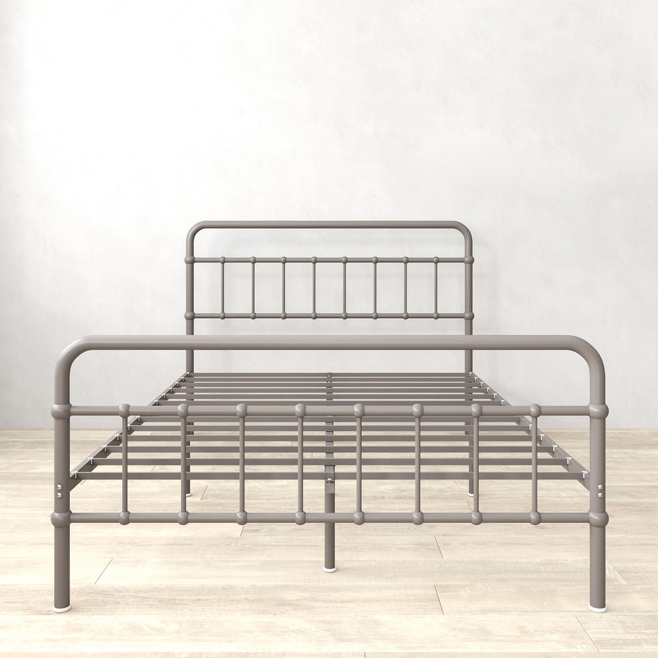 Front view of Zinus metal platform bed frame with headboard and footboard, shown in grey steel. Clean lines and durable slats create a supportive base for queen or full mattresses. Functional design eliminates need for box spring while maximizing durability and mattress life.