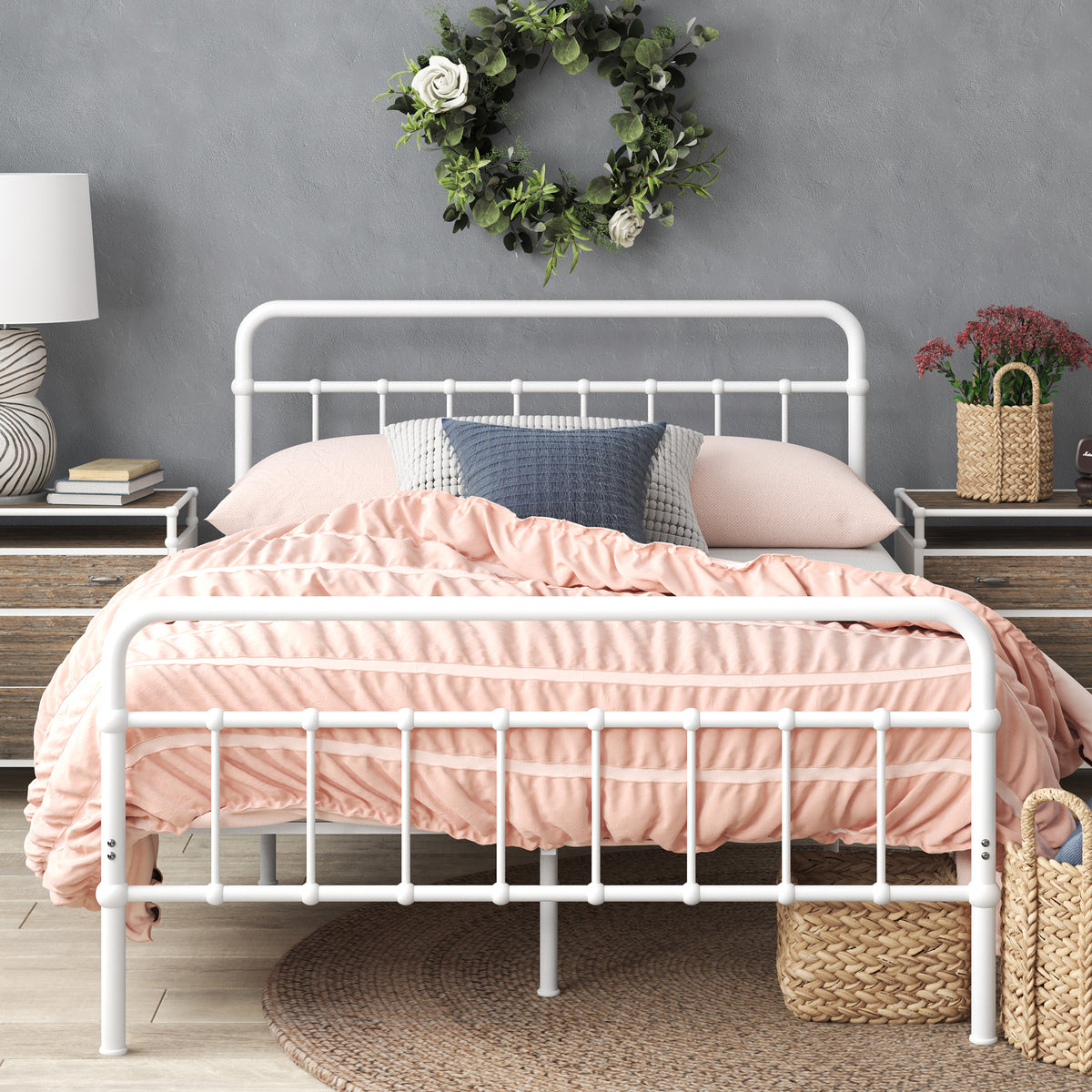 Styled bedroom featuring Zinus metal bed frame with headboard, dressed in pink bedding with decorative pillows and wicker storage basket beneath. Sturdy steel frame adds modern farmhouse charm while supporting queen or full mattresses with underbed storage space.