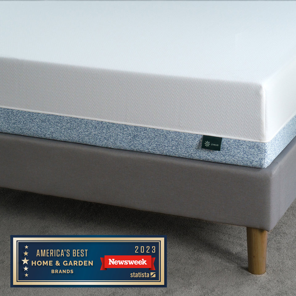 Zinus Original Green Tea Memory Foam Mattress displayed on platform bed. Infused with green tea extract and pressure-relieving foam for freshness and comfort. Awarded America’s Best Home & Garden Brand 2023 by Newsweek.