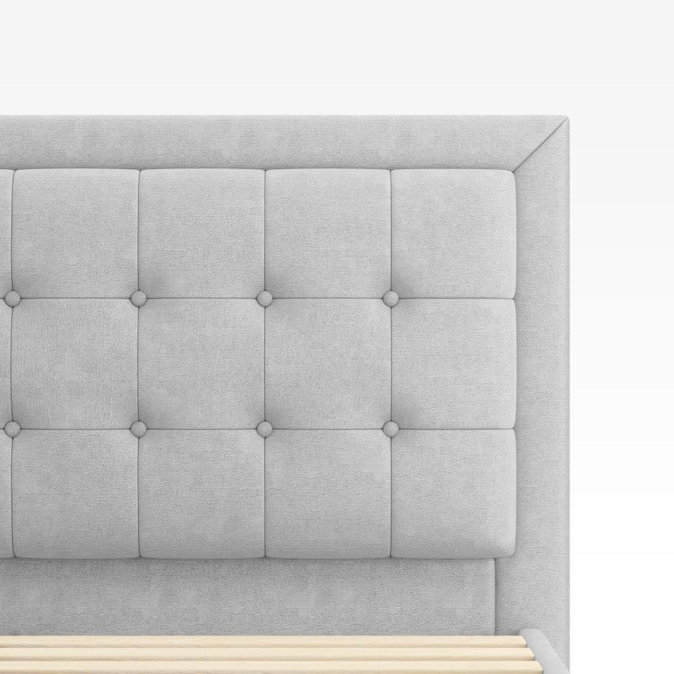 Close-up of Zinus Dachelle Upholstered Platform Bed Frame in light gray fabric. Square tufted padded headboard offers soft comfort and modern style, highlighting the clean lines and contemporary upholstered design.