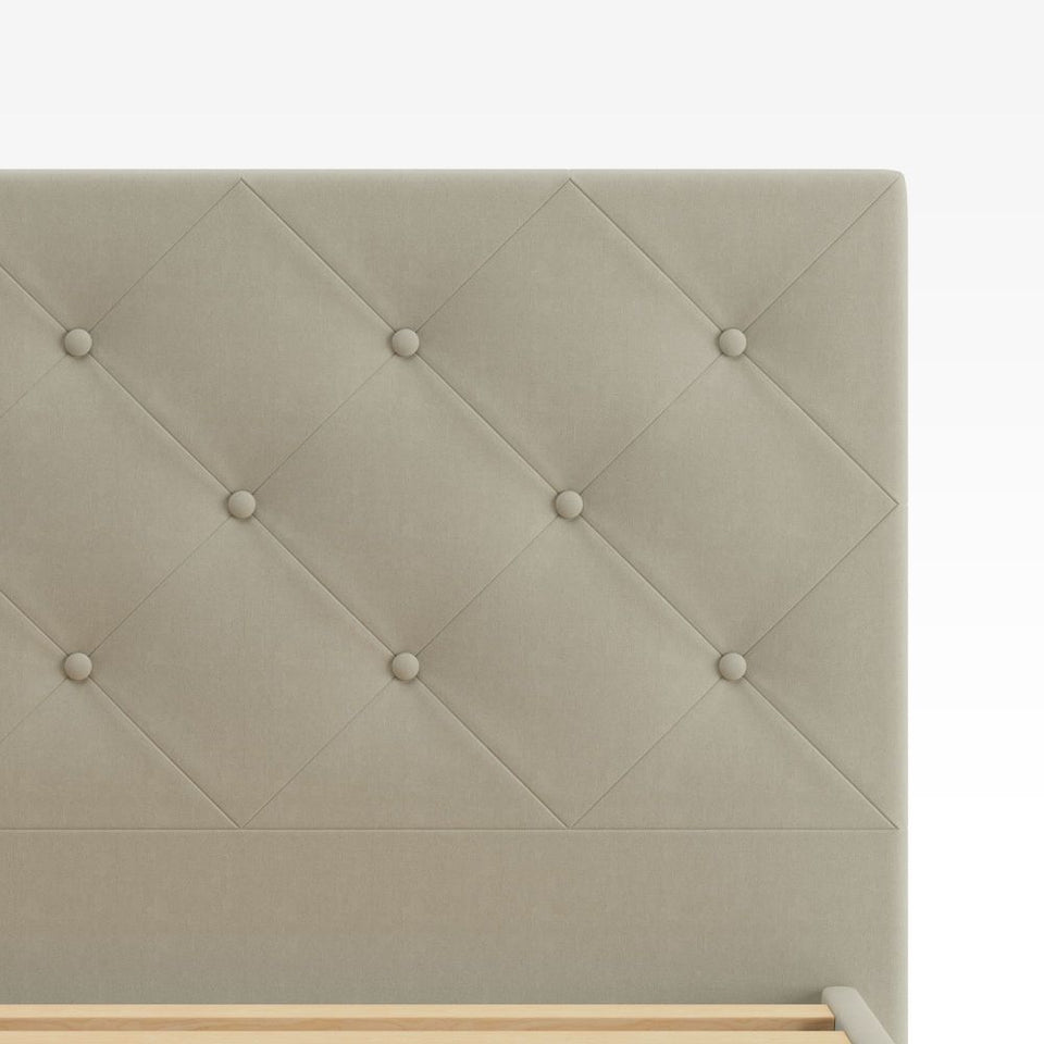 Close-up of Zinus Shalini Upholstered Platform Bed Frame headboard inbeige velvet fabric. The diamond-stitched, button-tufted design adds a touch of elegance and texture, enhancing bedroom décor while offering durable comfort and long-lasting style