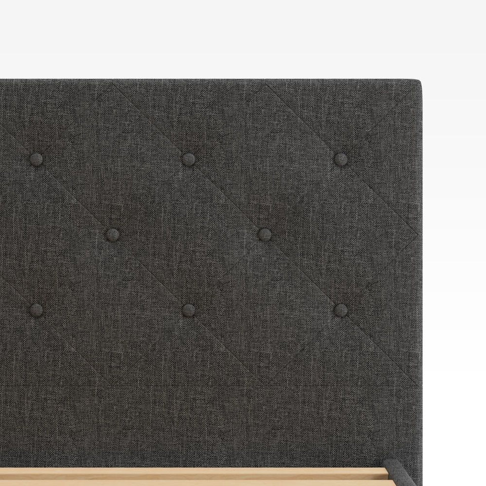 Close-up of Zinus Shalini Upholstered Platform Bed Frame headboard in dark gray fabric. The diamond-stitched, button-tufted design adds a touch of elegance and texture, enhancing bedroom décor while offering durable comfort and long-lasting style