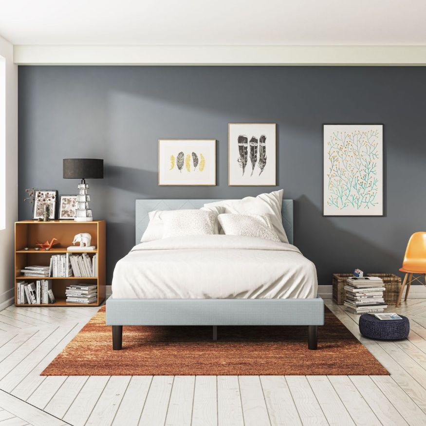 Zinus Shalini Upholstered Platform Bed Frame in a bright modern bedroom with white flooring and cozy décor. The light gray tufted headboard pairs with sturdy slats for reliable mattress support, combining function, durability, and timeless upholstered style.
