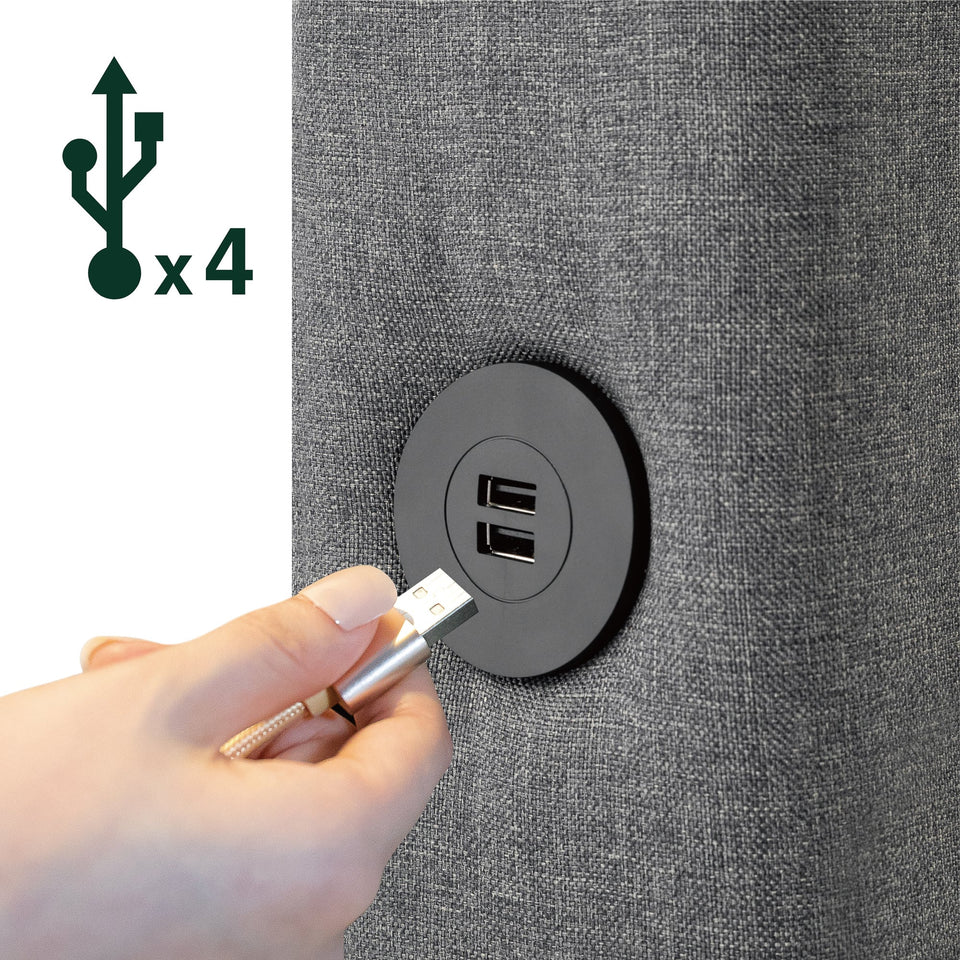 Detail of Zinus Upholstered Platform Bed Frame built-in USB ports, with user plugging cable into gray upholstered side panel. Four charging ports offer modern convenience, allowing easy bedside charging for devices while maintaining the bed’s sleek and functional design